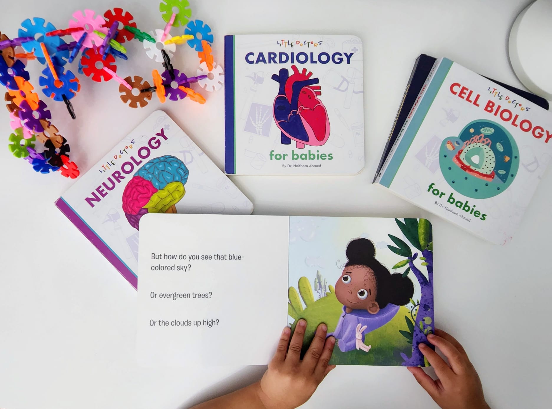 Child reading Ophthalmology with Cardiology, Neurology and Cell Biology books